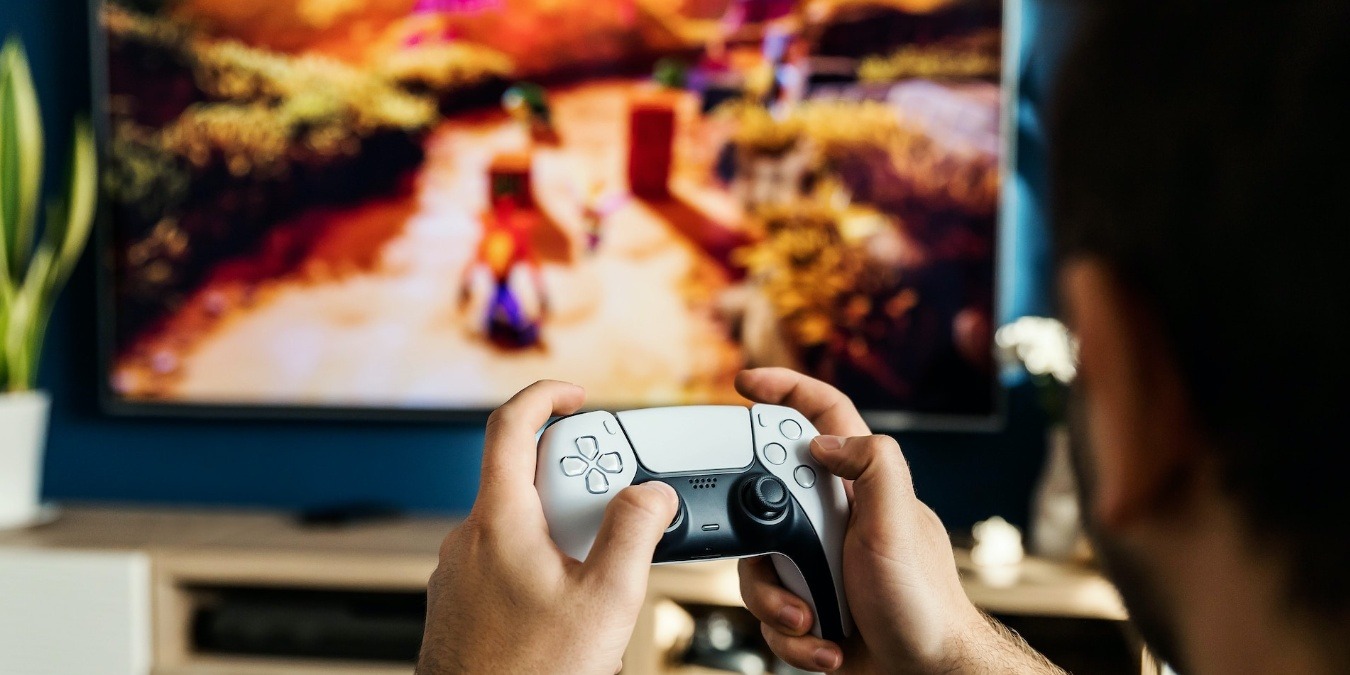 Man playing on the PS5 on a gaming TV